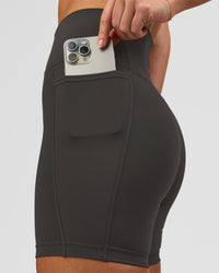 Woman wearing Fusion Ultra High-Rise 6" Short Pockets - Onyx | Model:Issy | Size:XS | Thumbnail Index: 4