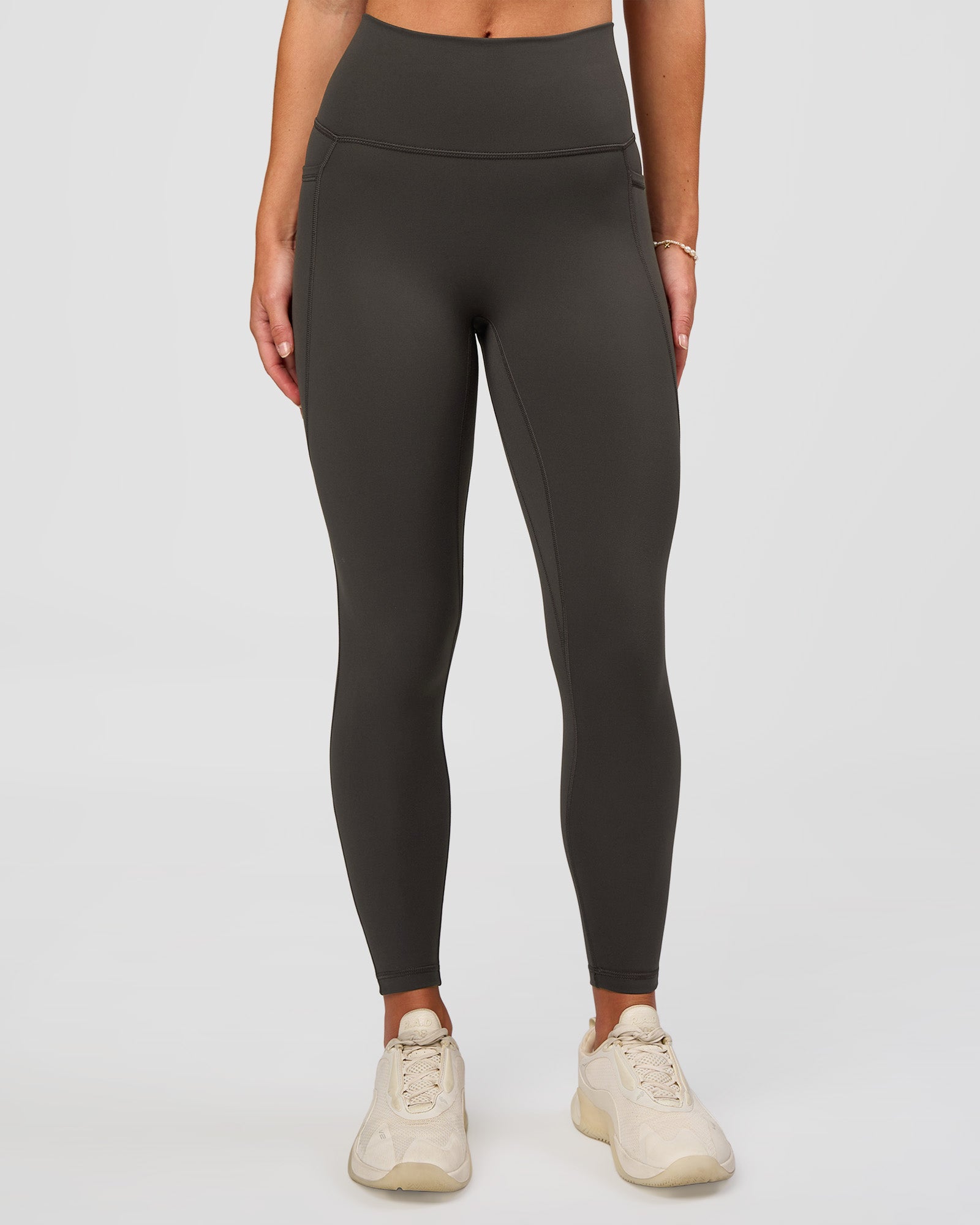Woman wearing Fusion Ultra High-Rise 7/8 Legging Pockets - Onyx | Model:Issy | Size:XS