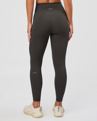 Woman wearing Fusion Ultra High-Rise 7/8 Legging Pockets - Onyx | Model:Issy | Size:XS | Thumbnail Index: 2