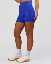 Woman wearing Fusion V-Contour Ultra High-Rise 4" Short Pockets - Power Cobalt | Model:Issy | Size:XS | Thumbnail Index: 6