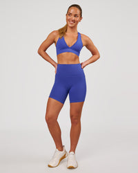 Woman wearing Fusion V-Contour Ultra High-Rise 6" Short Pockets - Power Cobalt | Model:Issy | Size:XS | Thumbnail Index: 3