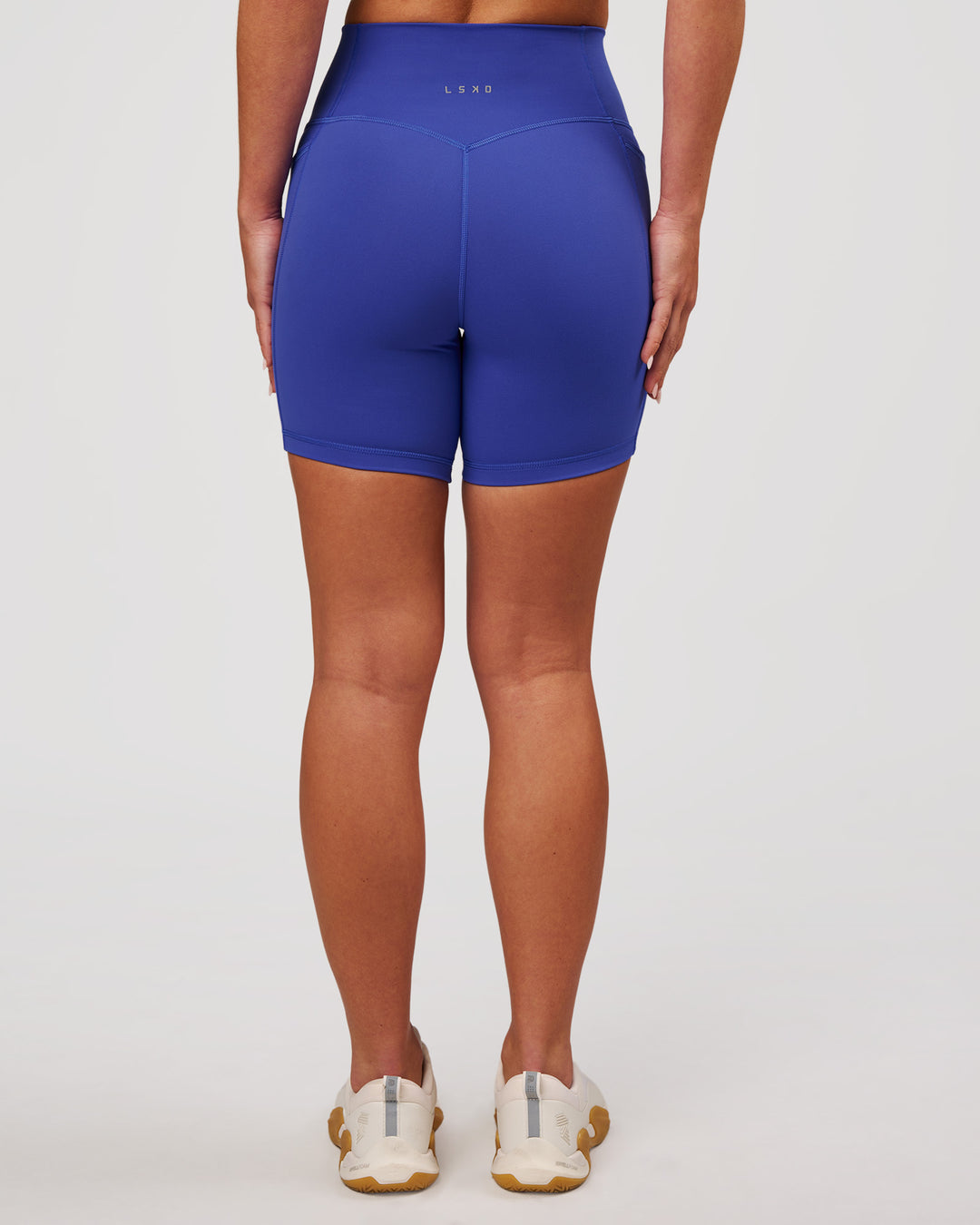 Woman wearing Fusion V-Contour Ultra High-Rise 6" Short Pockets - Power Cobalt | Model:Issy | Size:XS - view 7