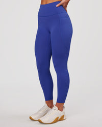 Woman wearing Fusion V-Contour Ultra High-Rise 7/8 Legging Pockets - Power Cobalt | Model:Issy | Size:XS | Thumbnail Index: 0