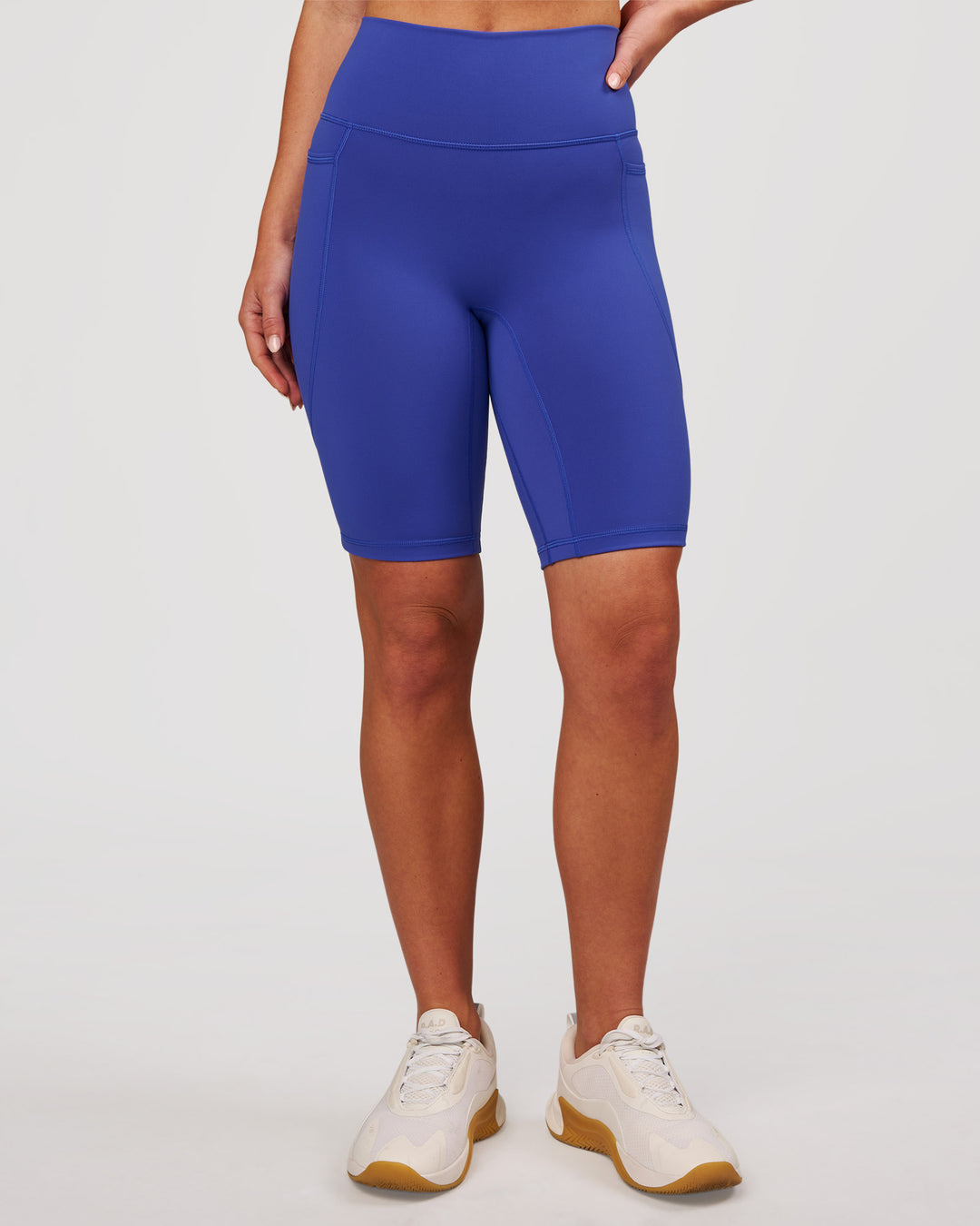 Woman wearing Fusion V Contour Ultra High-Rise 9" Short Pockets - Power Cobalt | Model:Issy | Size:XS - view 4