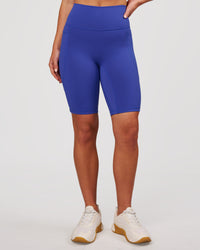 Woman wearing Fusion V Contour Ultra High-Rise 9" Short Pockets - Power Cobalt | Model:Issy | Size:XS | Thumbnail Index: 3