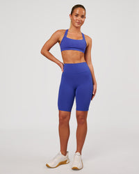 Woman wearing Fusion V Contour Ultra High-Rise 9" Short Pockets - Power Cobalt | Model:Issy | Size:XS | Thumbnail Index: 4
