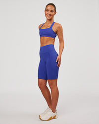 Woman wearing Fusion V Contour Ultra High-Rise 9" Short Pockets - Power Cobalt | Model:Issy | Size:XS | Thumbnail Index: 5