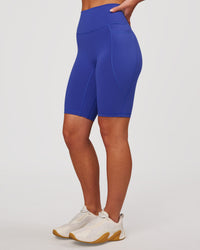Woman wearing Fusion V Contour Ultra High-Rise 9" Short Pockets - Power Cobalt | Model:Issy | Size:XS | Thumbnail Index: 6