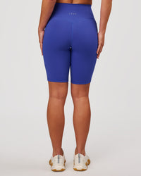 Woman wearing Fusion V Contour Ultra High-Rise 9" Short Pockets - Power Cobalt | Model:Issy | Size:XS | Thumbnail Index: 7