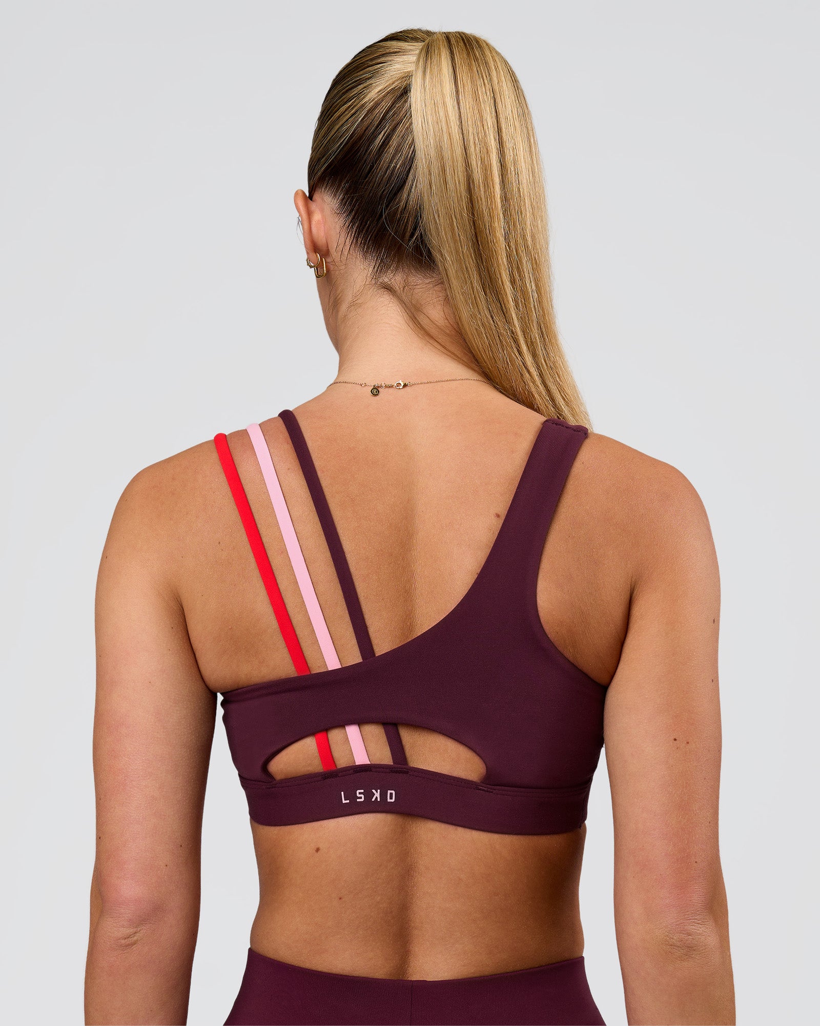 Woman wearing Galvanise Sports Bra 2.0 - Cherry Lacquer-Multi | Model:Issy | Size:XS