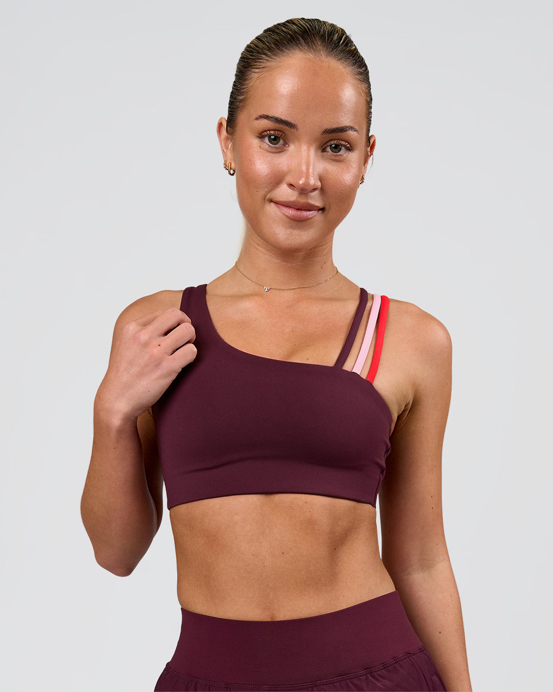 Woman wearing Galvanise Sports Bra 2.0 - Cherry Lacquer-Multi | Model:Issy | Size:XS - view 3