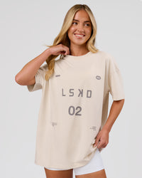 Woman wearing Game Plan Heavyweight FLXCotton Oversized Tee - Vanilla Bean | Model:Issy | Size:XS | Thumbnail Index: 1