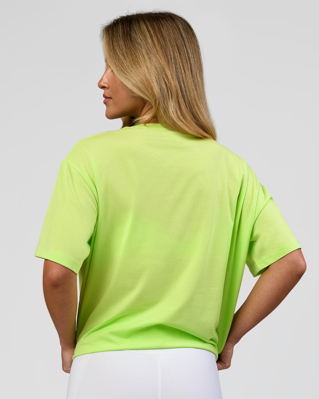 Woman wearing Go-To FLXCotton Oversized Tee - Lime Glo-White | Model:Issy | Size:XS - view 3