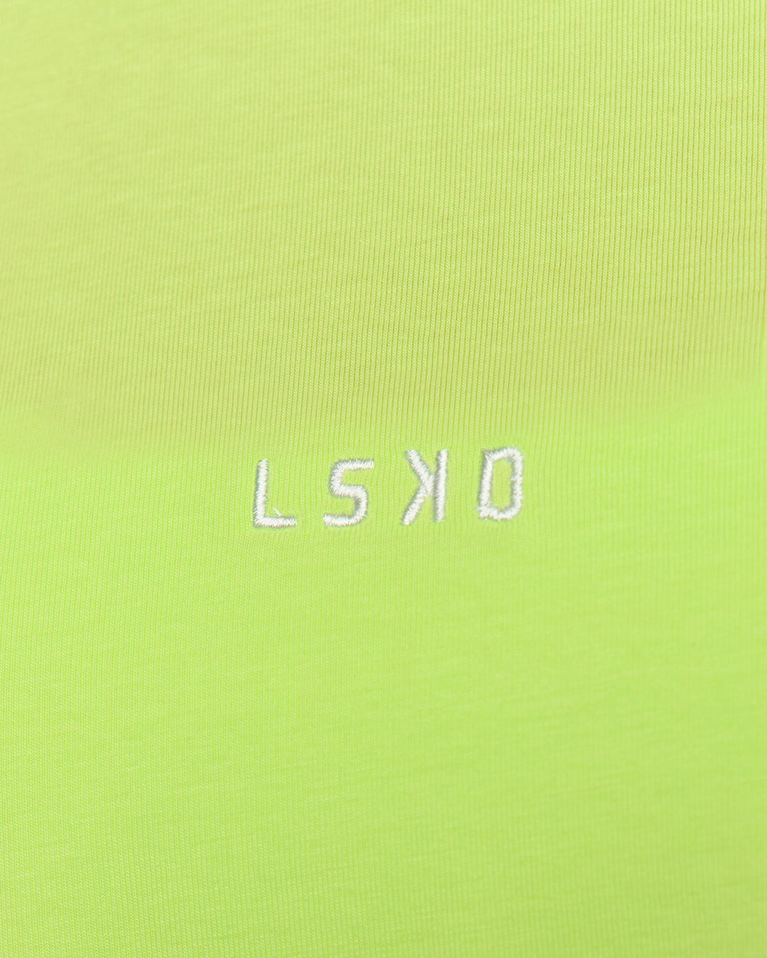 Woman wearing Go-To FLXCotton Oversized Tee - Lime Glo-White | Model:Issy | Size:XS - view 4