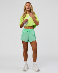 Woman wearing Go-To FLXCotton Oversized Tee - Lime Glo-White | Model:Issy | Size:XS | Thumbnail Index: 7