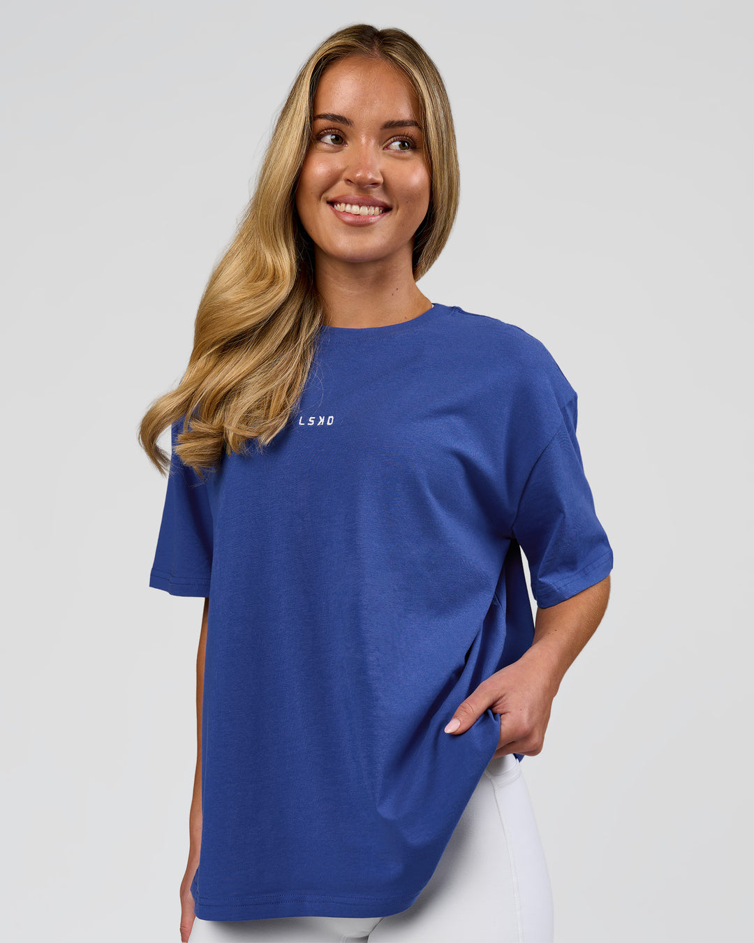 Woman wearing Go-To FLXCotton Oversized Tee - Power Cobalt-White | Model:Issy | Size:XS - view 1