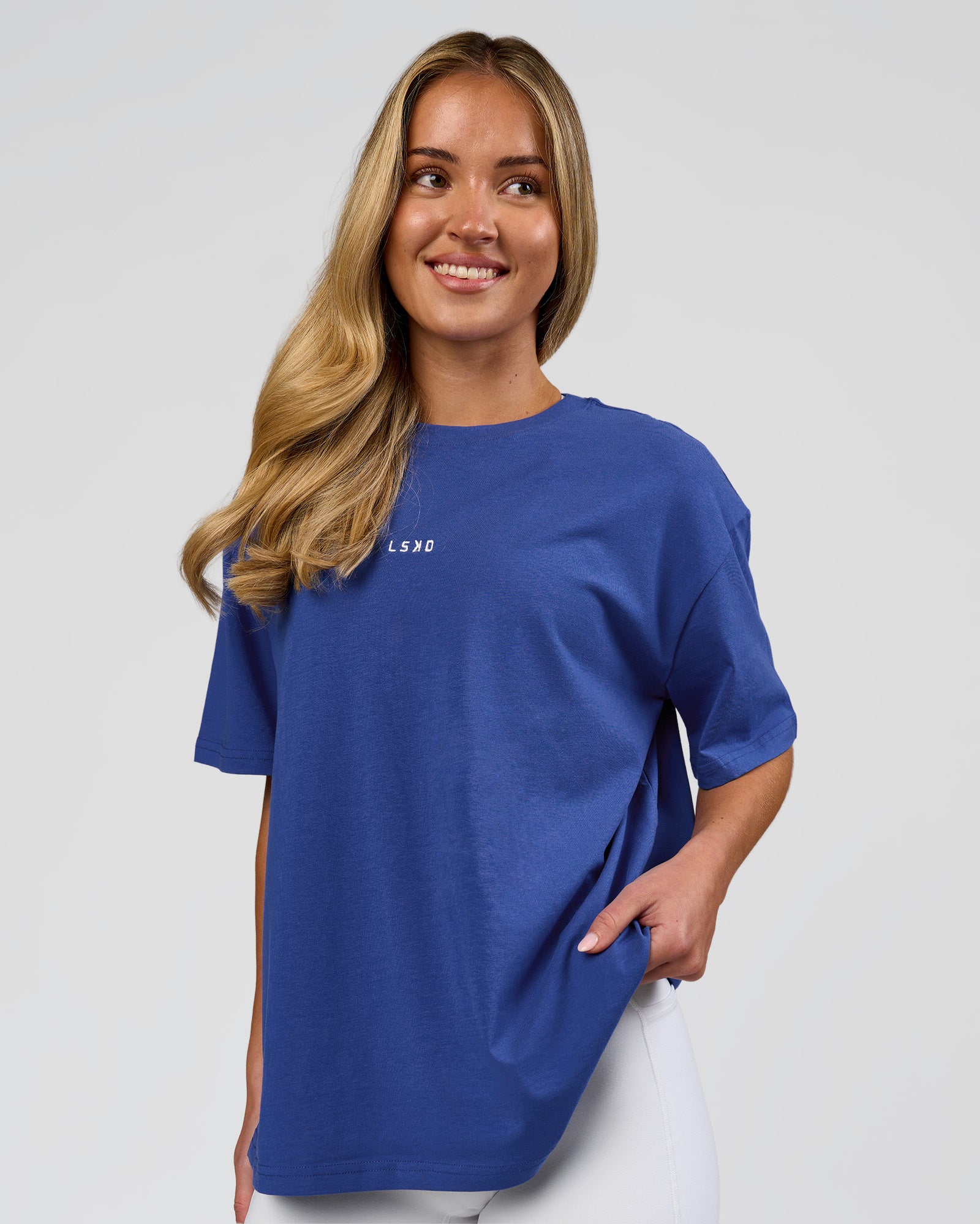 Woman wearing Go-To FLXCotton Oversized Tee - Power Cobalt-White | Model:Issy | Size:XS