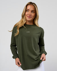 Woman wearing Go-To Long Sleeve FLXCotton Oversized Tee - Pure Olive-White | Model:Issy | Size:XS | Thumbnail Index: 0