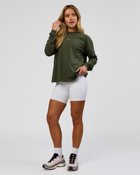 Woman wearing Go-To Long Sleeve FLXCotton Oversized Tee - Pure Olive-White | Model:Issy | Size:XS | Thumbnail Index: 3