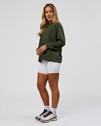 Woman wearing Go-To Long Sleeve FLXCotton Oversized Tee - Pure Olive-White | Model:Issy | Size:XS | Thumbnail Index: 5