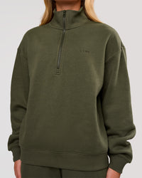 Woman wearing Go-To Oversized Quarter Zip Sweater - Pure Olive | Model:Issy | Size:XS | Thumbnail Index: 1