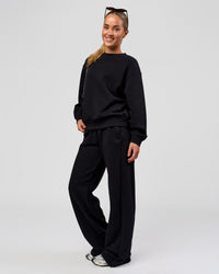 Woman wearing Go-To Oversized Sweater - Black | Model:Issy | Size:XS