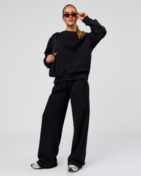 Woman wearing Go-To Oversized Sweater - Black | Model:Issy | Size:XS