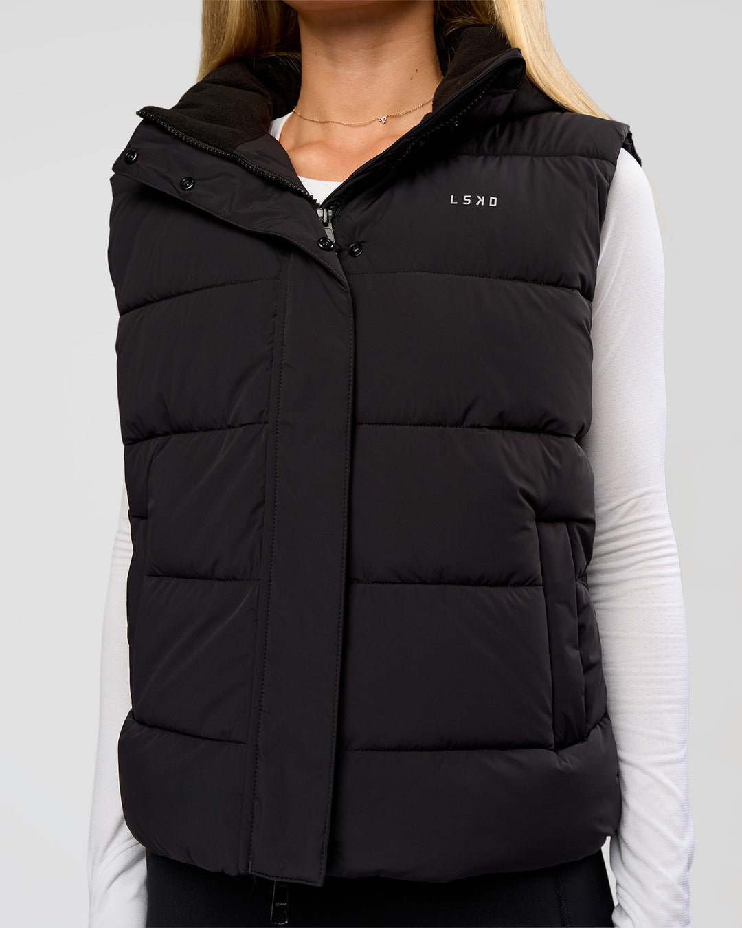 Woman wearing Go-To Puffer Vest - Black | Model:Issy | Size:XS