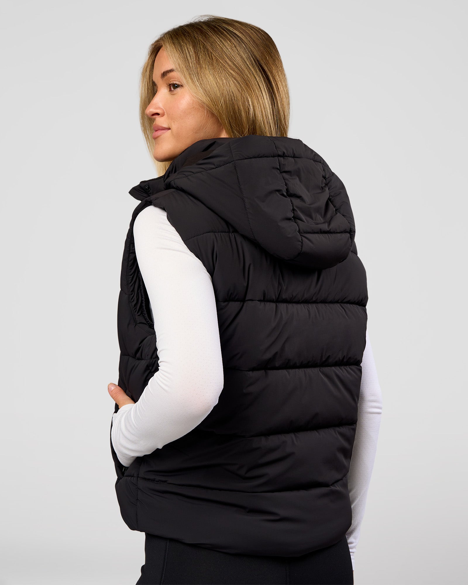 Woman wearing Go-To Puffer Vest - Black | Model:Issy | Size:XS