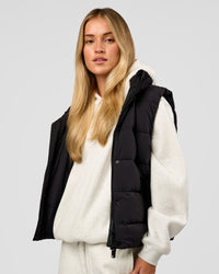 Woman wearing Go-To Puffer Vest - Black | Model:Issy | Size:XS