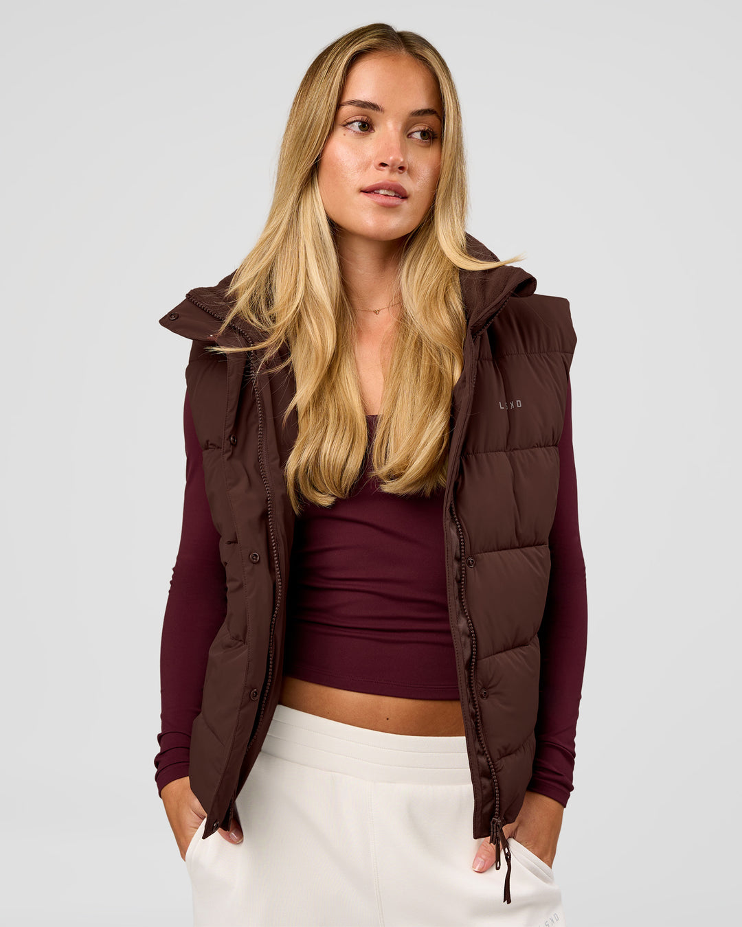 Woman wearing Go-To Puffer Vest - Hot Chocolate | Model:Issy | Size:XS