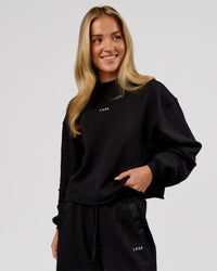 Woman wearing Go-To Terry Oversized Pull Over - Black-White | Model:Issy | Size:XS | Thumbnail Index: 2