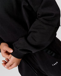 Woman wearing Go-To Terry Oversized Pull Over - Black-White | Model:Issy | Size:XS | Thumbnail Index: 7