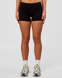 Woman wearing Groovy High Rise Fold Over 4" Short - Black | Model:Issy | Size:XS