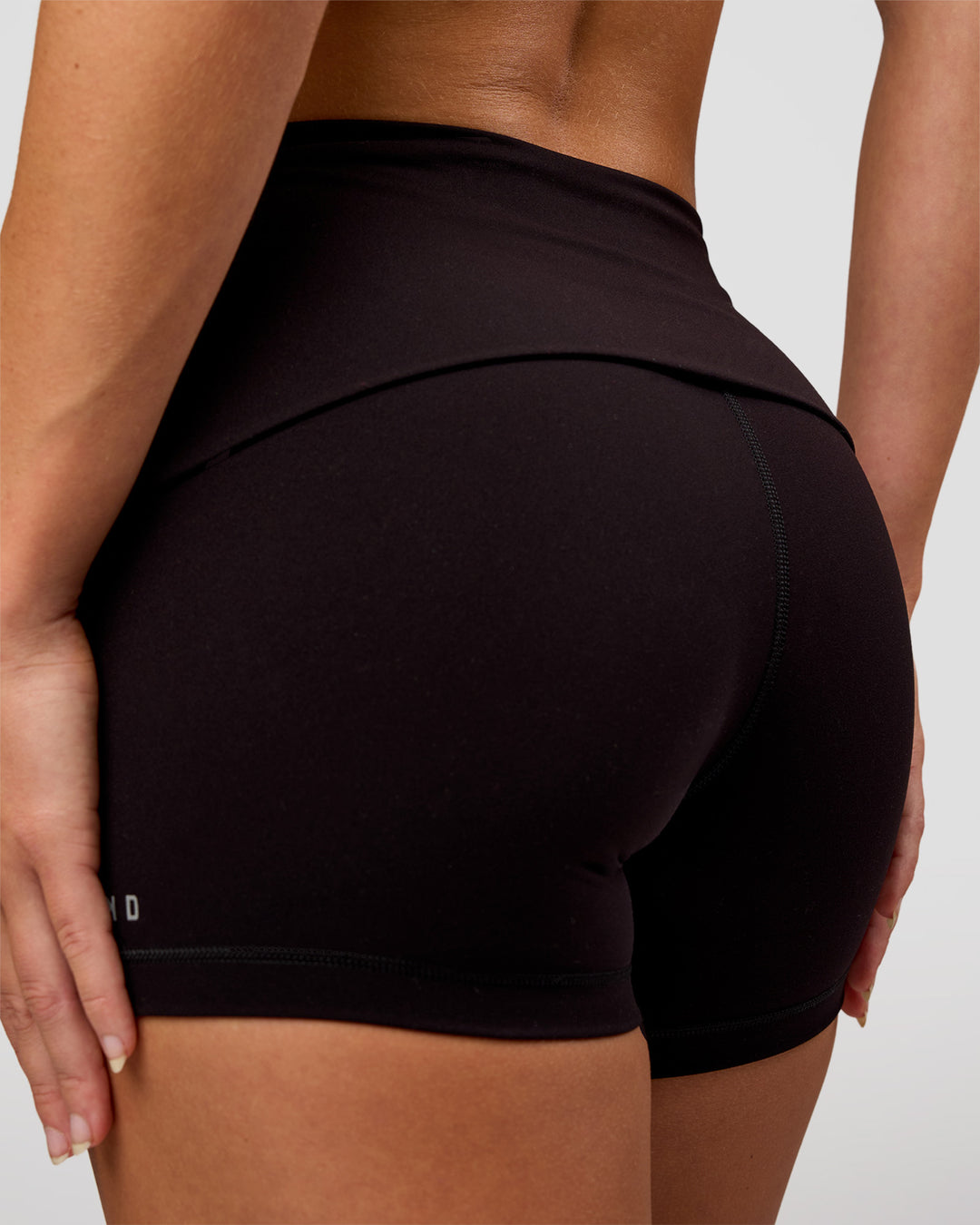 Woman wearing Groovy High Rise Fold Over 4" Short - Black | Model:Issy | Size:XS