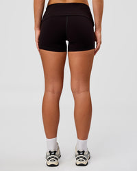 Woman wearing Groovy High Rise Fold Over 4" Short - Black | Model:Issy | Size:XS