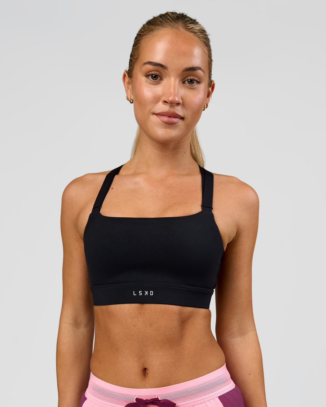 Woman wearing High Velocity Sports Bra - Black | Model:Issy | Size:XS - view 1
