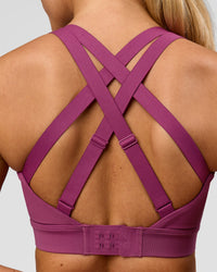 Woman wearing High Velocity Sports Bra - Boysenberry | Model:Issy | Size:XS | Thumbnail Index: 1