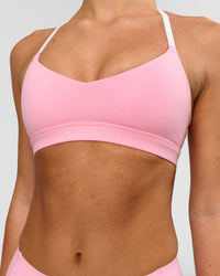Woman wearing Infinity Sports Bra - Pink Rose | Model:Issy | Size:XS | Thumbnail Index: 0