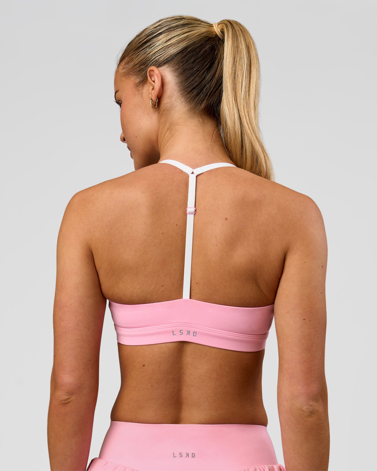 Woman wearing Infinity Sports Bra - Pink Rose | Model:Issy | Size:XS
