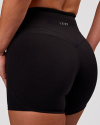 Woman wearing Luxe V-Contour High-Rise 4" Short - Black | Model:Issy | Size:XS | Thumbnail Index: 0