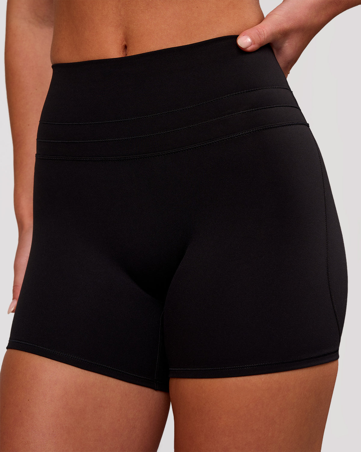 Woman wearing Luxe V-Contour High-Rise 4" Short - Black | Model:Issy | Size:XS