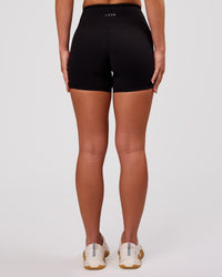 Woman wearing Luxe V-Contour High-Rise 4" Short - Black | Model:Issy | Size:XS | Thumbnail Index: 4