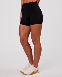 Woman wearing Luxe V-Contour High-Rise 4" Short - Black | Model:Issy | Size:XS | Thumbnail Index: 5