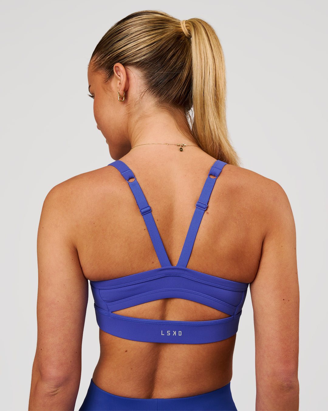 Woman wearing Momentum Sports Bra - Power Cobalt | Model:Issy | Size:XS - view 2