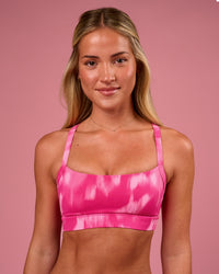 Woman wearing Momentum Sports Bra - Radiant Pink | Model:Issy | Size:XS | Thumbnail Index: 0