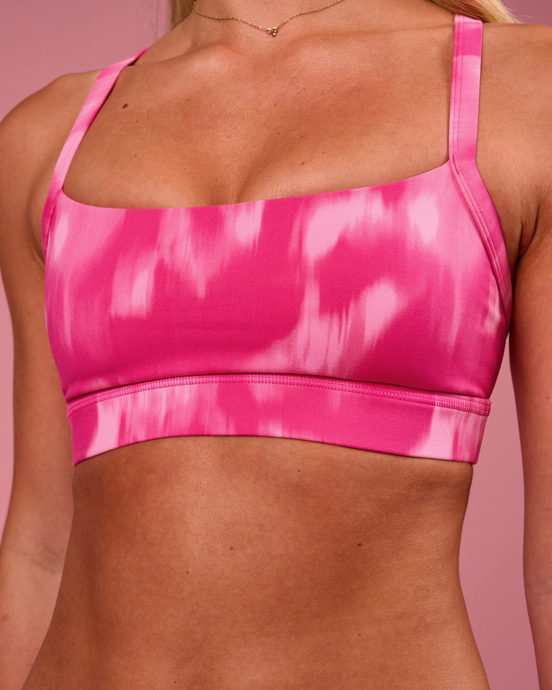 Woman wearing Momentum Sports Bra - Radiant Pink | Model:Issy | Size:XS - view 3