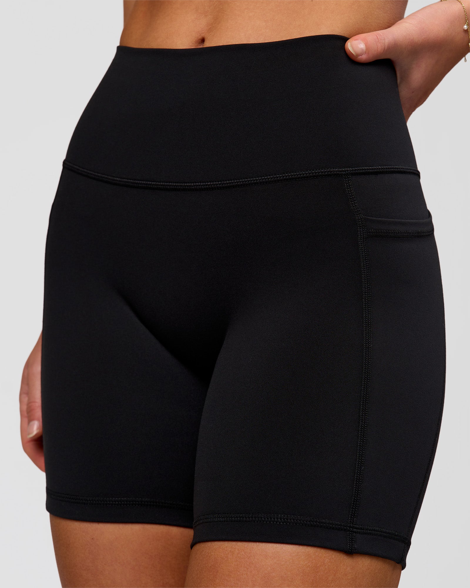 Woman wearing O.G. Fusion Ultra High-Rise 6" Short Pockets - Black | Model:Issy | Size:XS