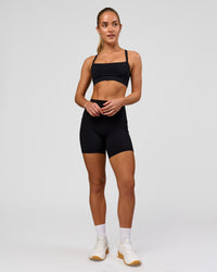 Woman wearing O.G. Fusion Ultra High-Rise 6" Short Pockets - Black | Model:Issy | Size:XS | Thumbnail Index: 12