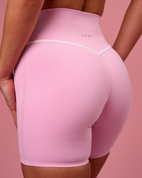 Woman wearing Pinnacle High-Rise 6" Short - Pink Rose-White | Model:Issy | Size:XS | Thumbnail Index: 0